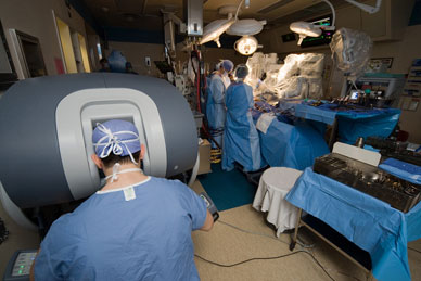 Image of robot-assisted surgery with surgeon at control console